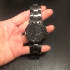 All black womens MK watch with black rhinestones around face.